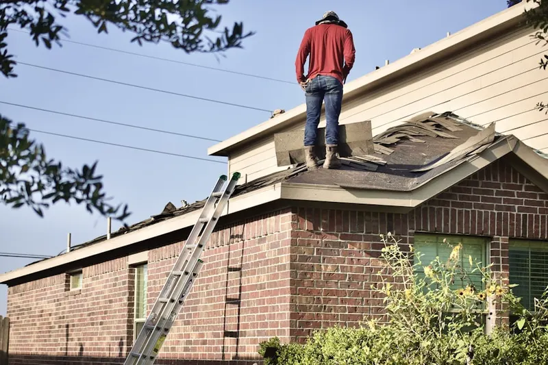 Professional roofer working on a residential roof in Providence Green